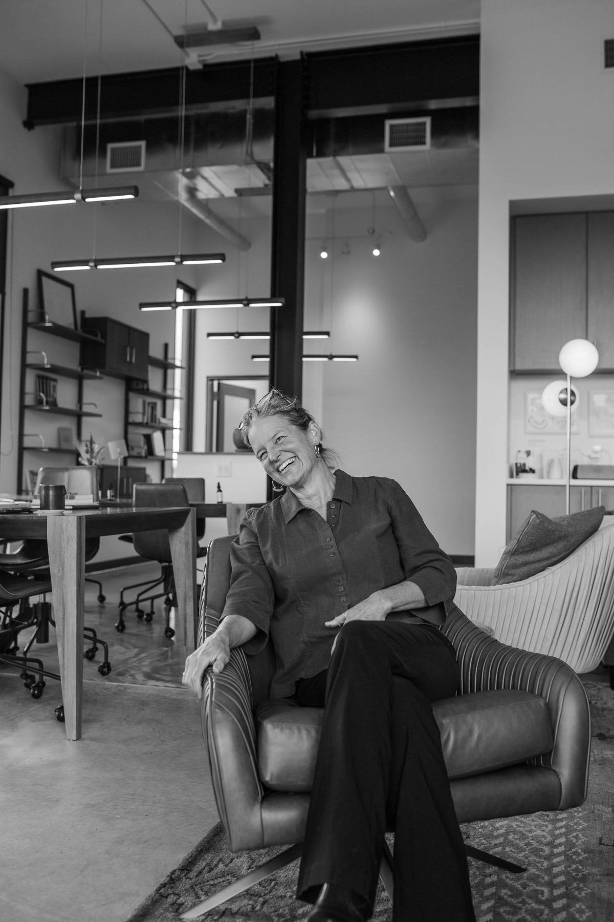 Lorca Smetana laughing, seated in an armchair